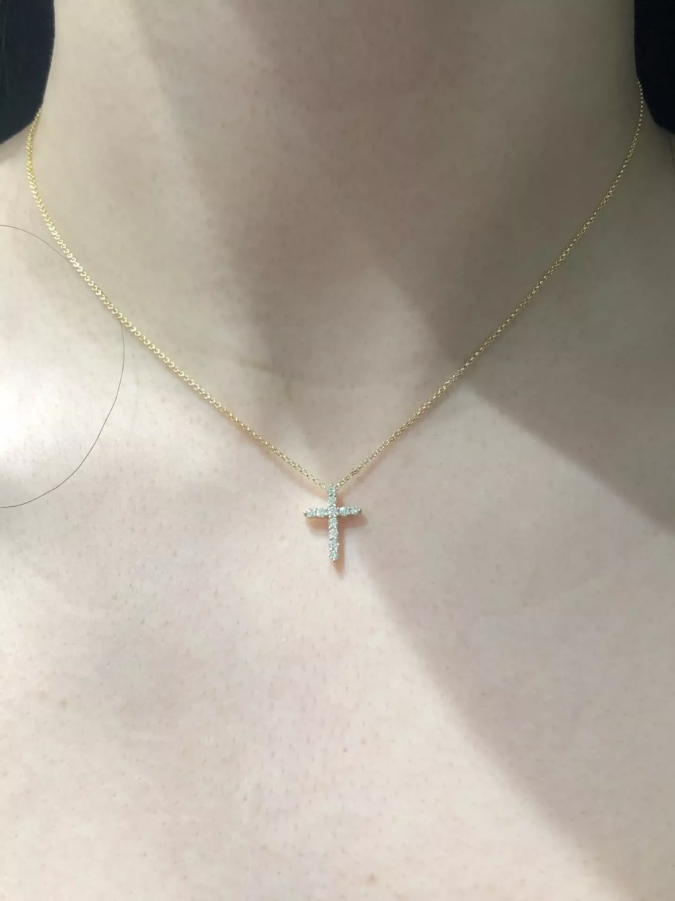 18ct yellow gold diamond cross necklace on the neck