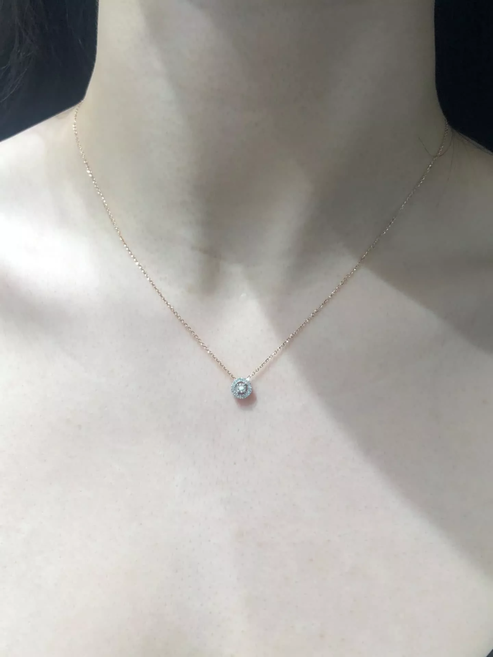 18ct rose gold round cluster diamond halo necklace on the neck