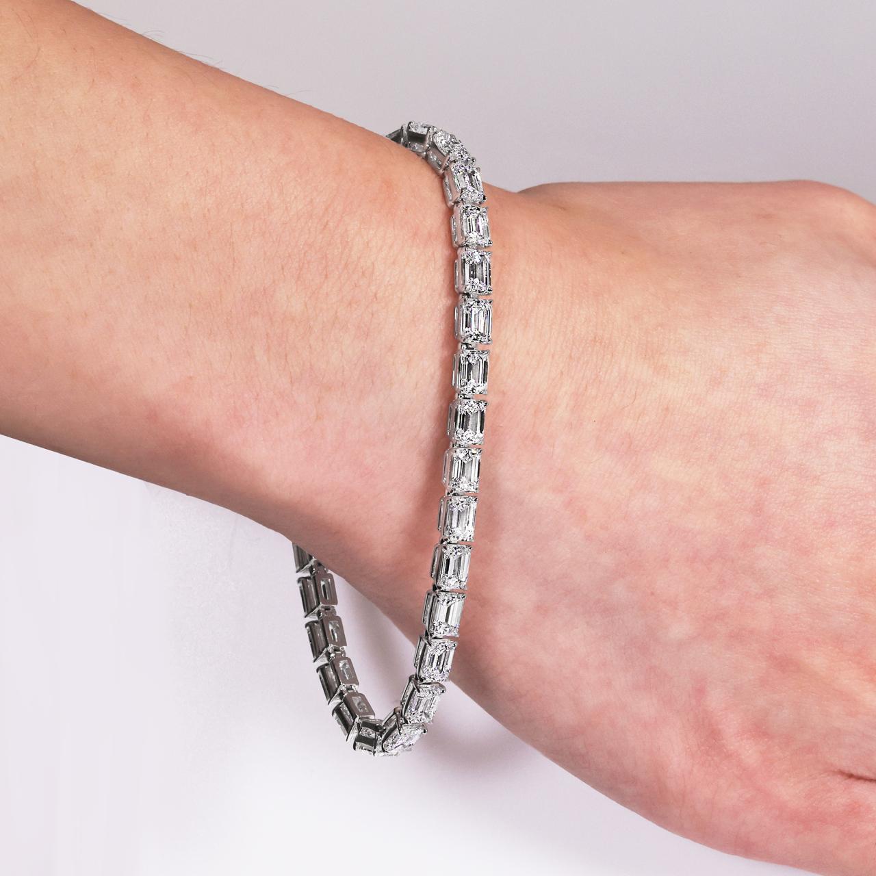 Platinum and 18ct rose gold emerald cut diamond tennis bracelet with certified pink and blue diamond clasp on wrist