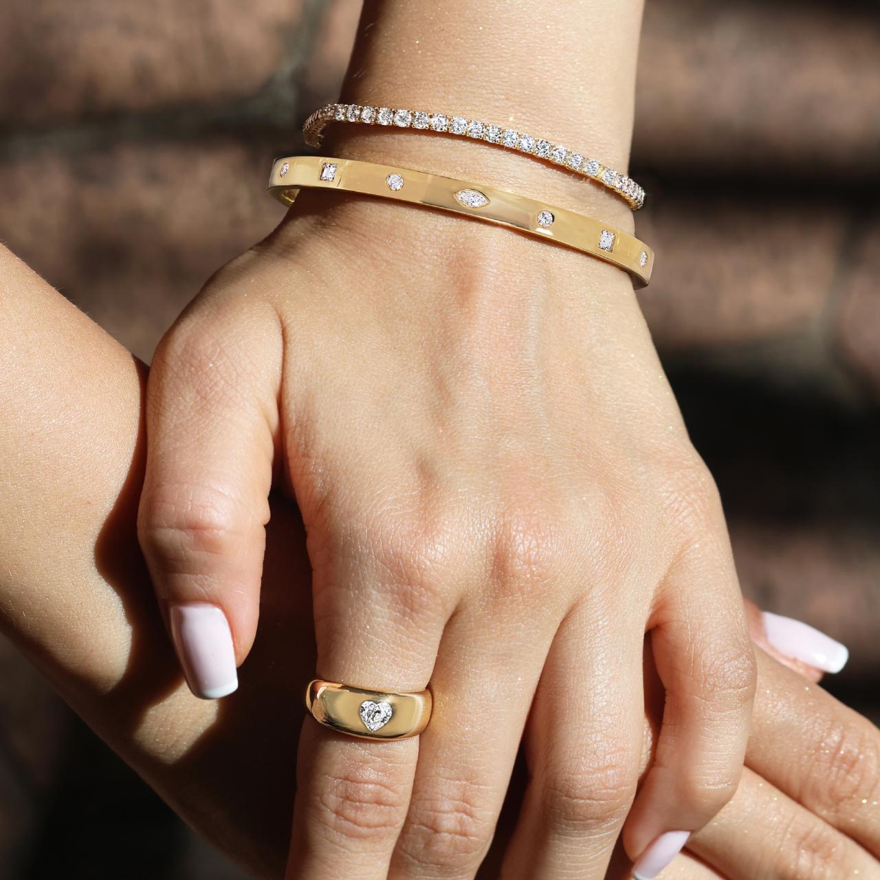 18ct yellow gold heart shaped diamond ring on the finger