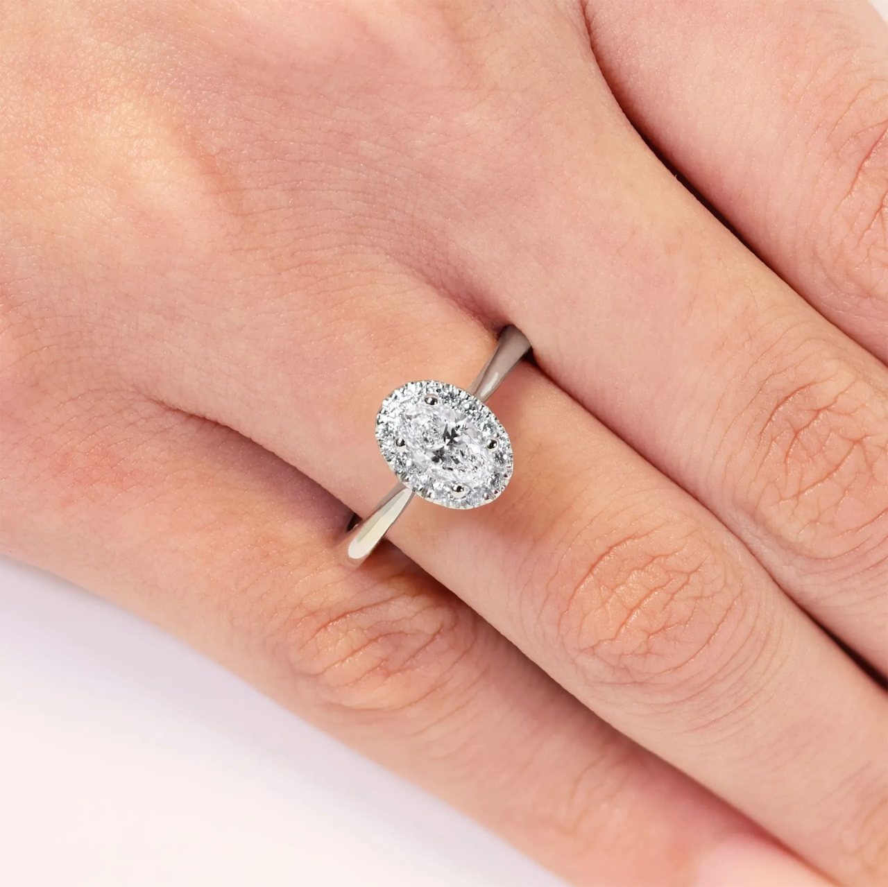 18ct white gold oval and round brilliant cut diamond halo ring