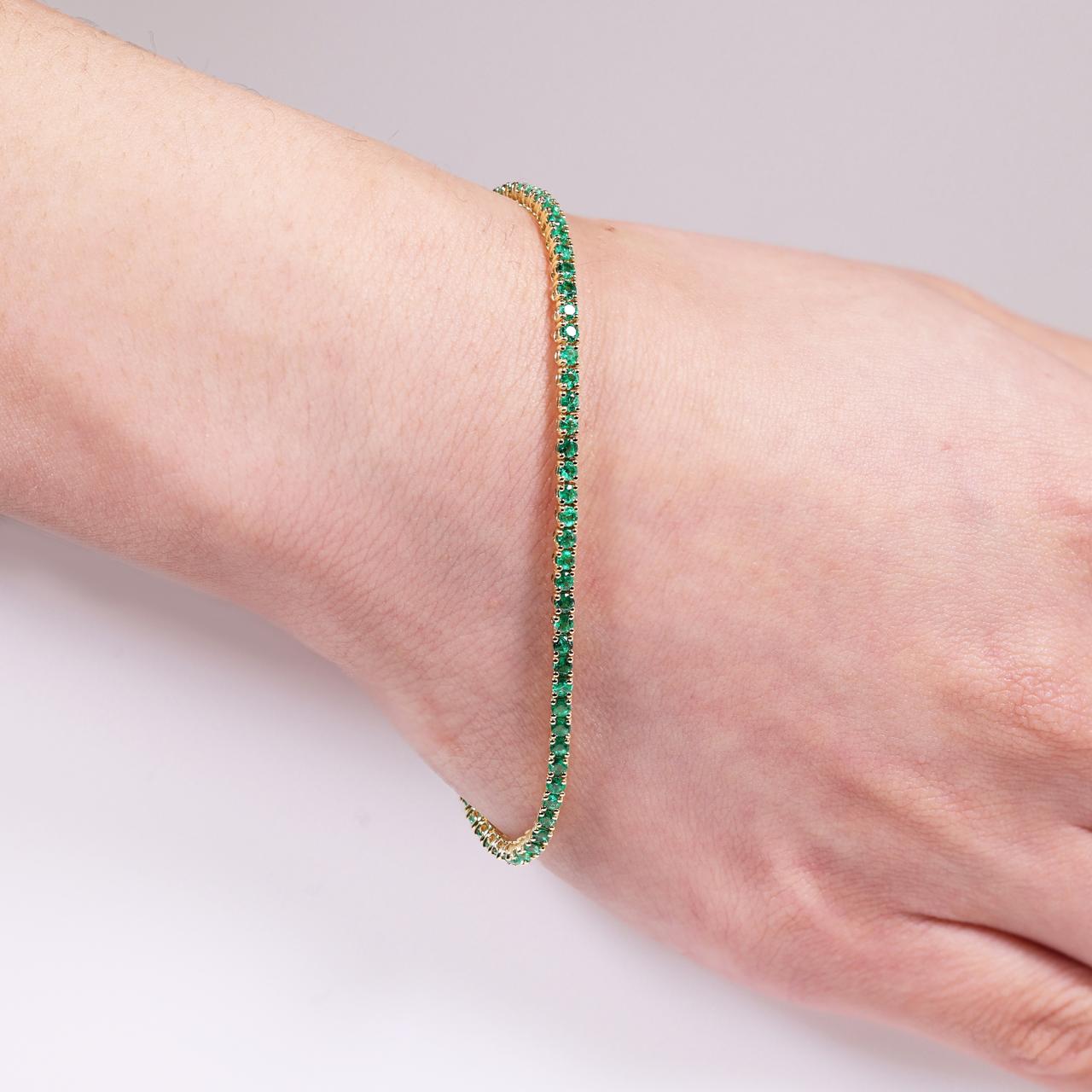 18ct yellow gold emerald bracelet on wrist