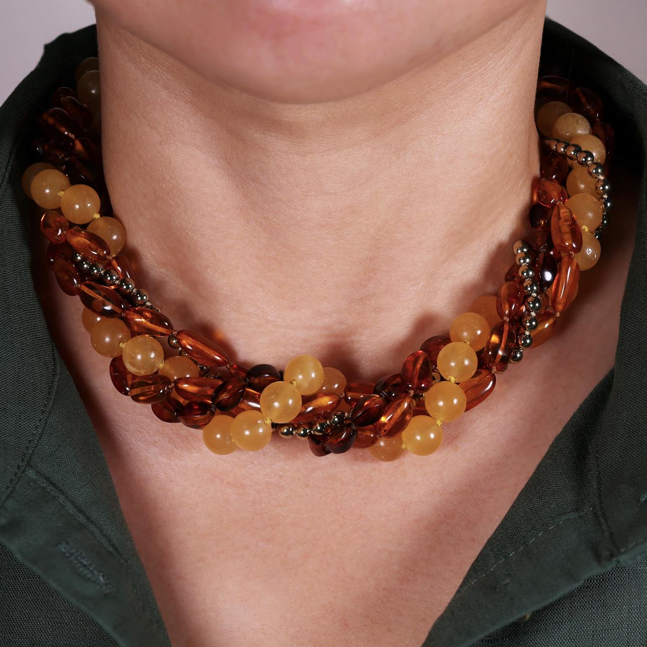 Amber, single row of gold plated hemitite and single row of orange calcite beaded necklace on the neck