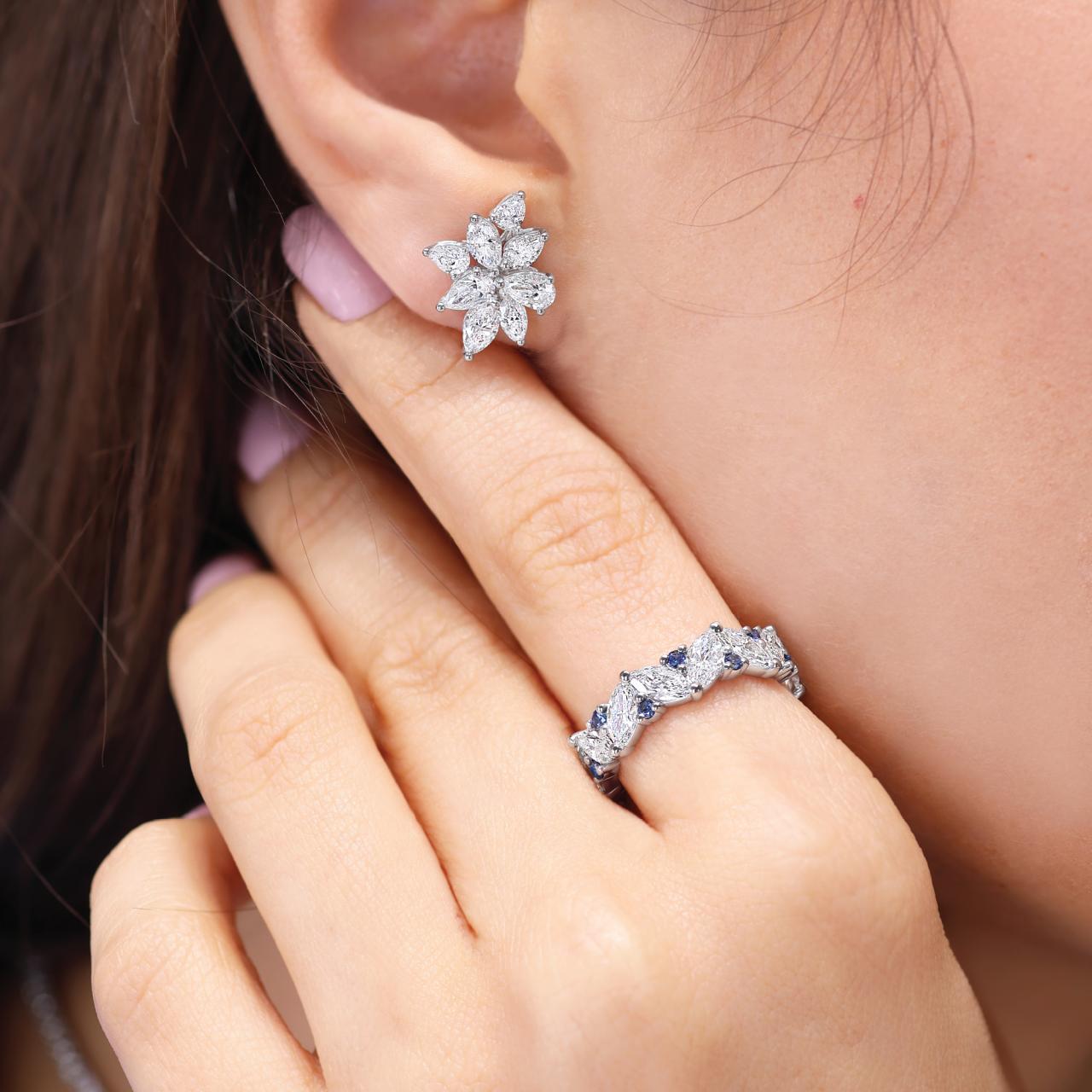 Platinum and 18ct white gold pear and marquise cut diamonds claw set stud earrings on the ear