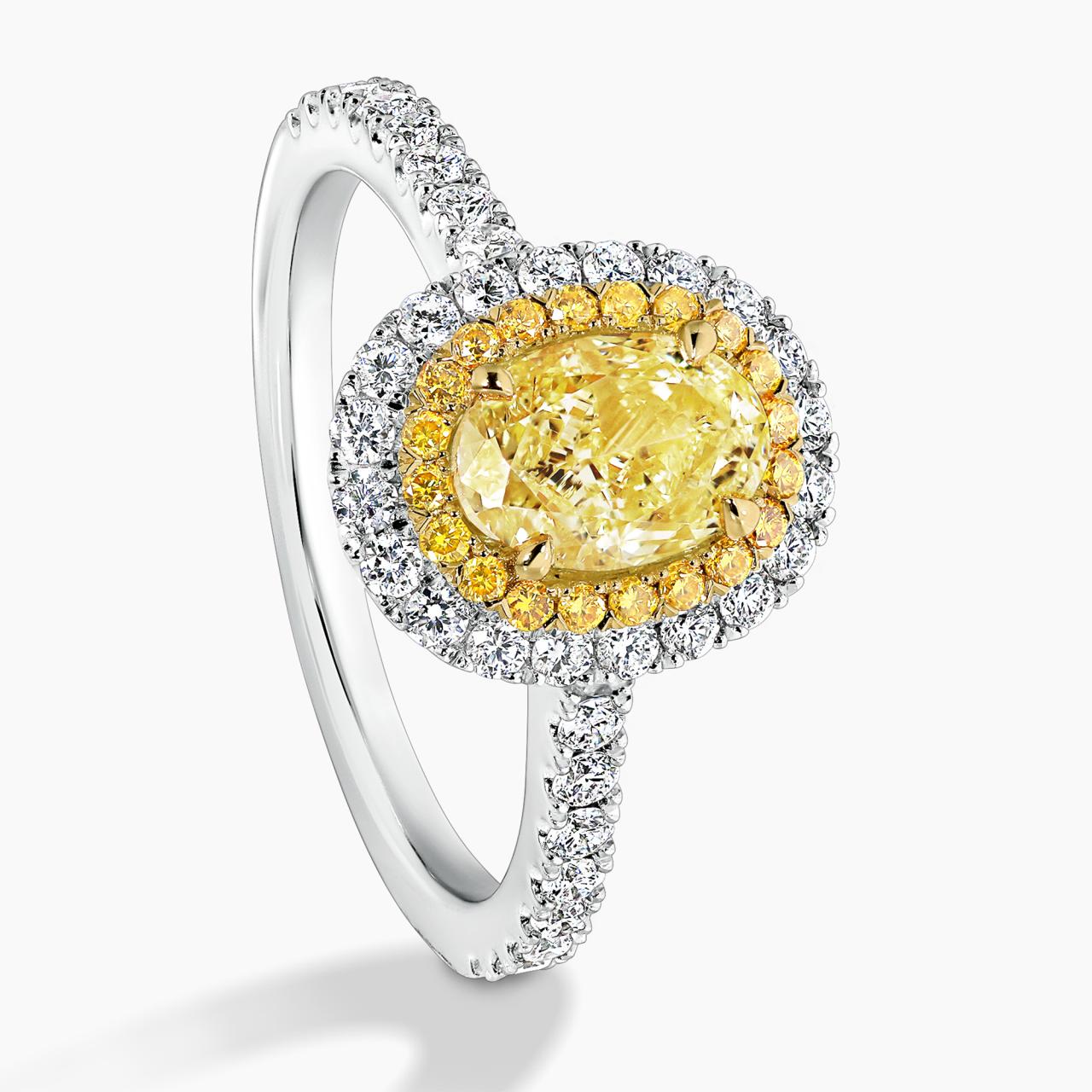 Platinum and 18ct yellow gold 1.04ct Fancy Intense Yellow oval and round diamond double halo ring