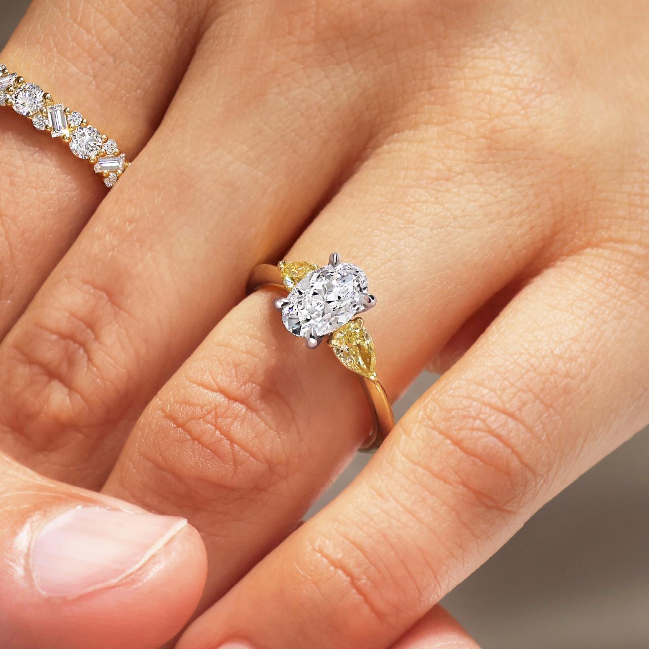 18ct yellow and white gold 1.20ct oval shape and pear shaped diamonds ring