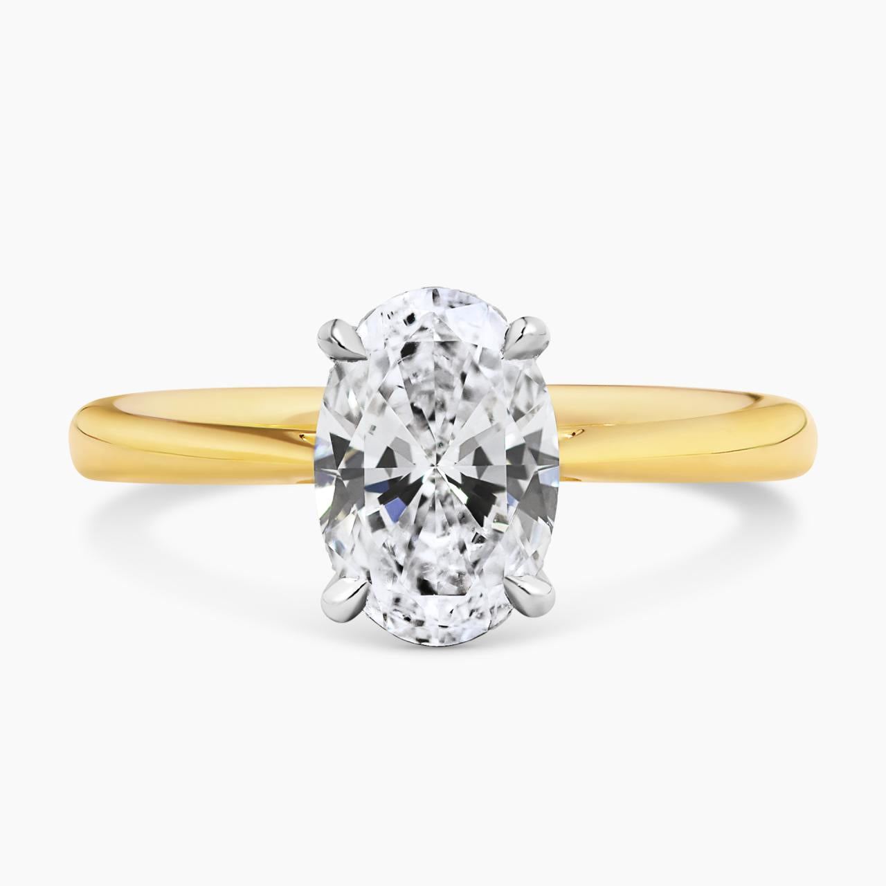 18ct yellow and white gold oval brilliant cut diamond ring in a four claw setting with hidden halo