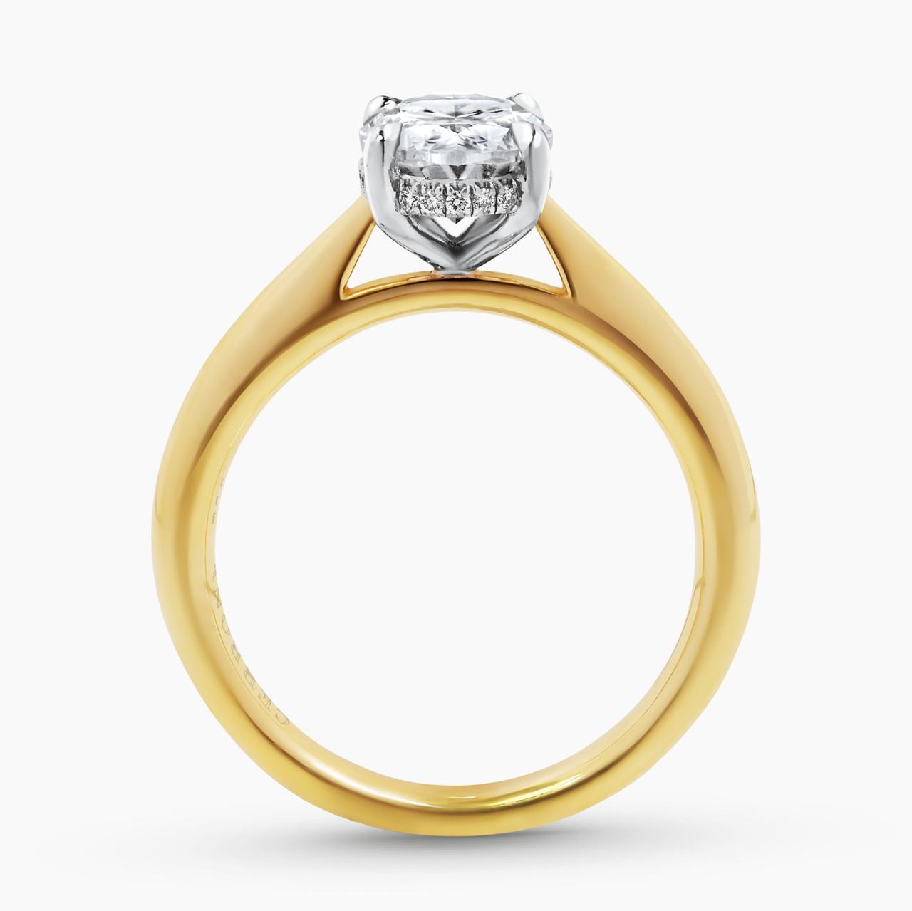 18ct yellow and white gold oval brilliant cut diamond ring in a four claw setting with hidden halo