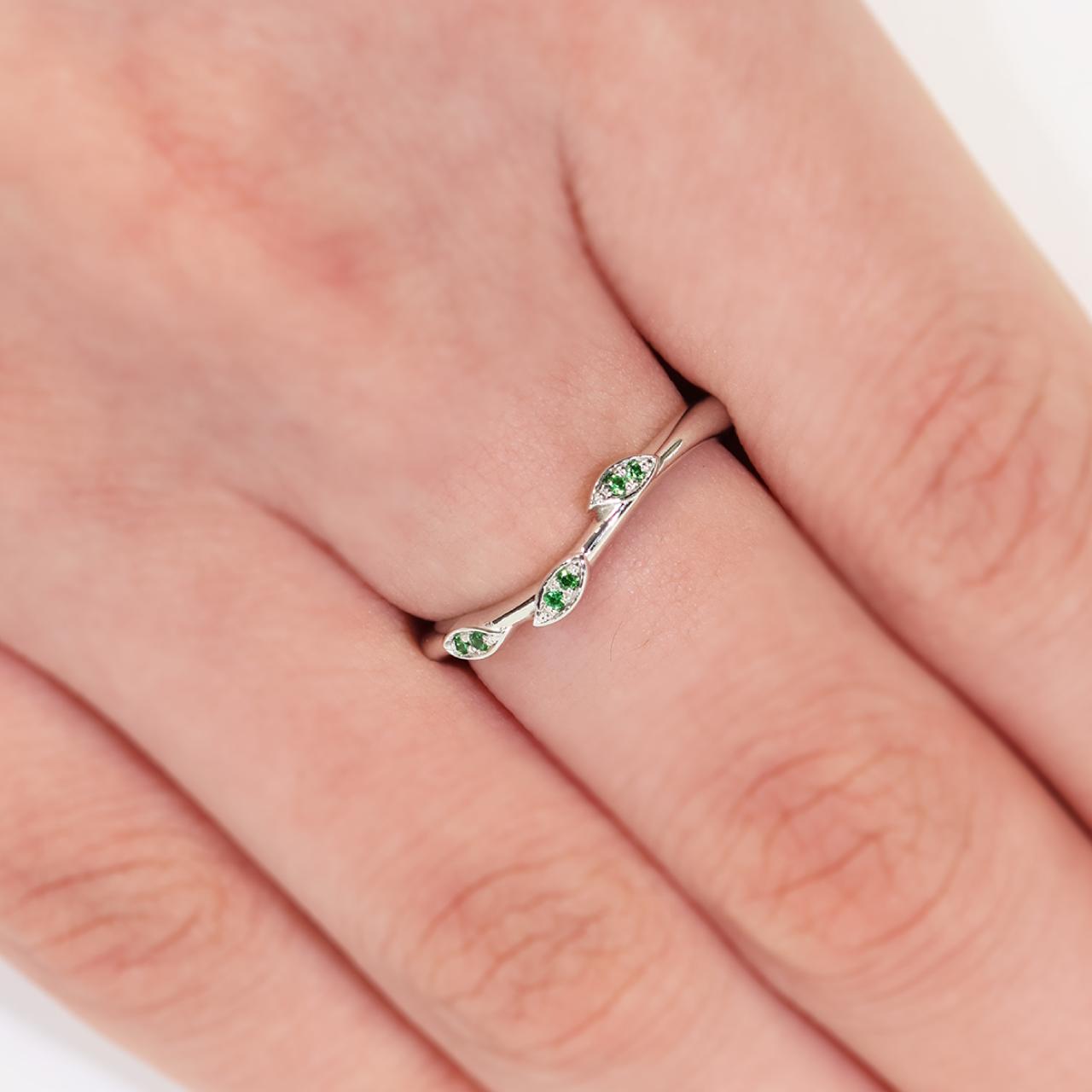 Platinum tsavorite garnet ring on the finger