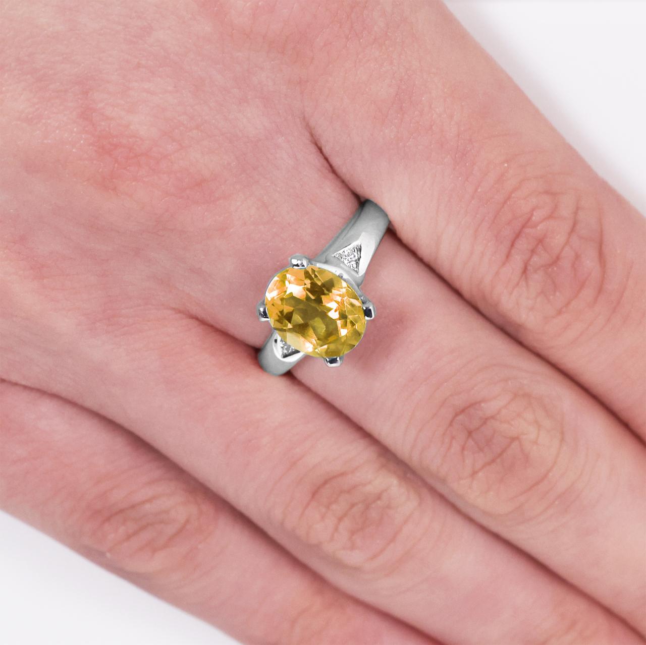 18ct white gold oval citrine and diamond ring on the finger