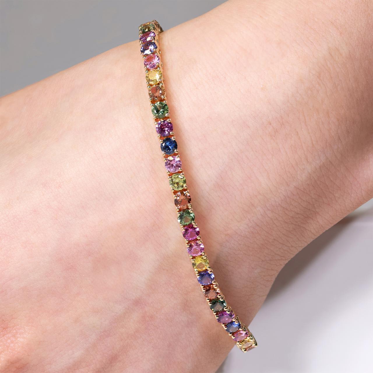 18ct yellow gold 45=12.11ct fancy pastel round brilliant cut sapphire four claw set bracelet
