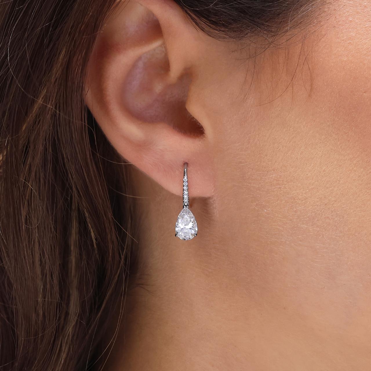 18ct white gold pear and round brilliant cut lab grown diamond shepherds hook drop earrings on the ear