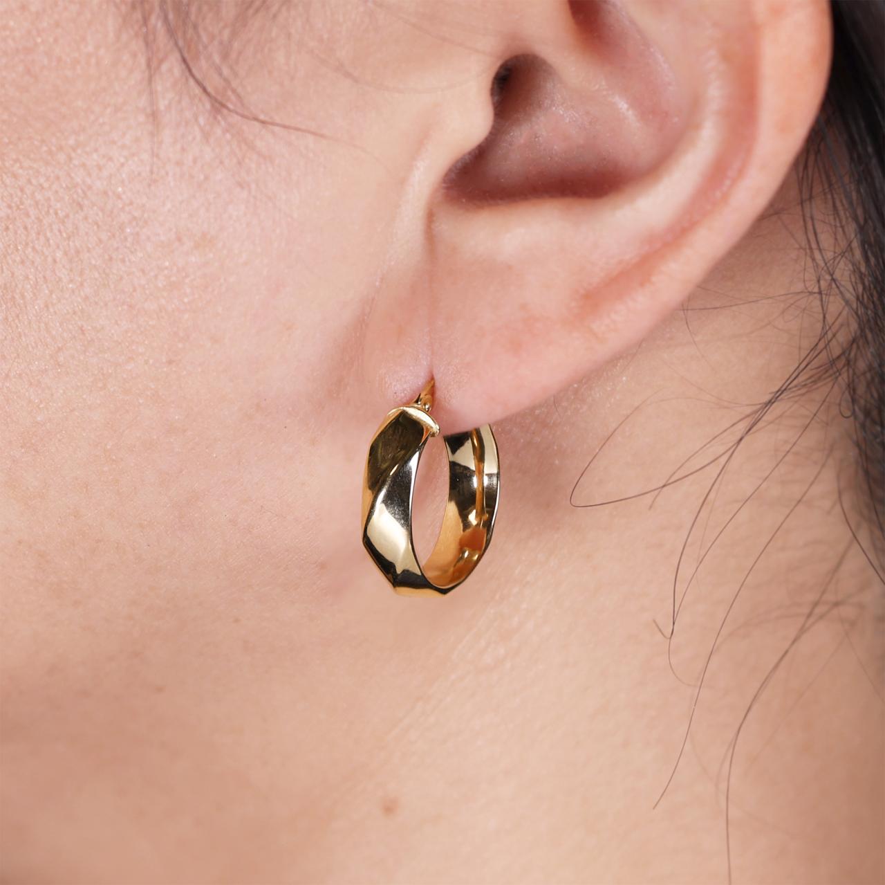 18ct yellow gold hollow faceted hoop earrings on the ear