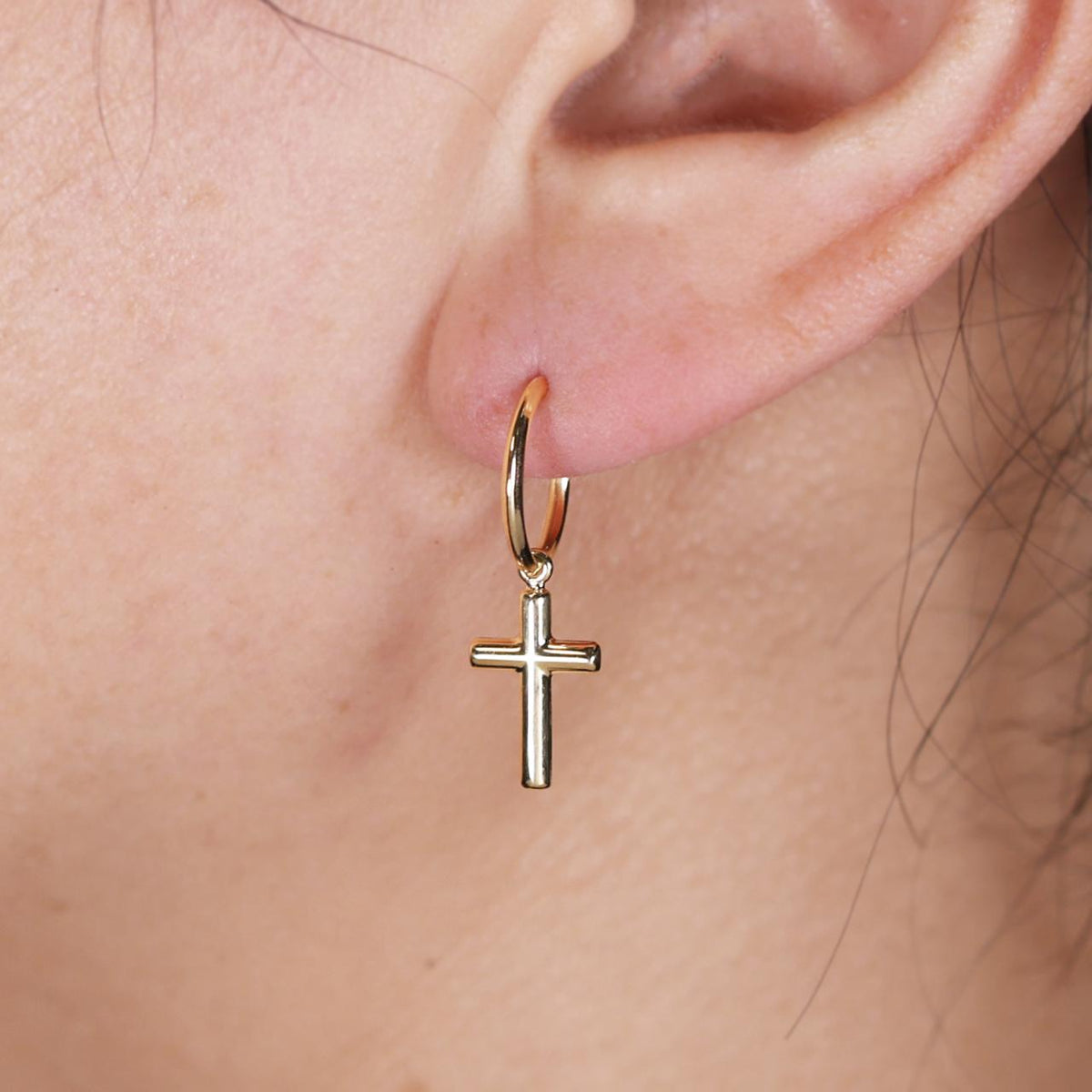 18ct yellow gold hoop cross drop earrings on the ear