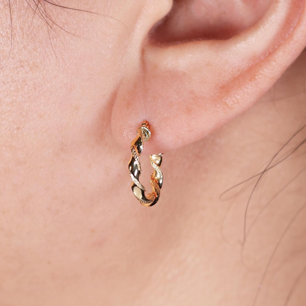 18ct yellow gold hollow plait small hoop earrings on the ear