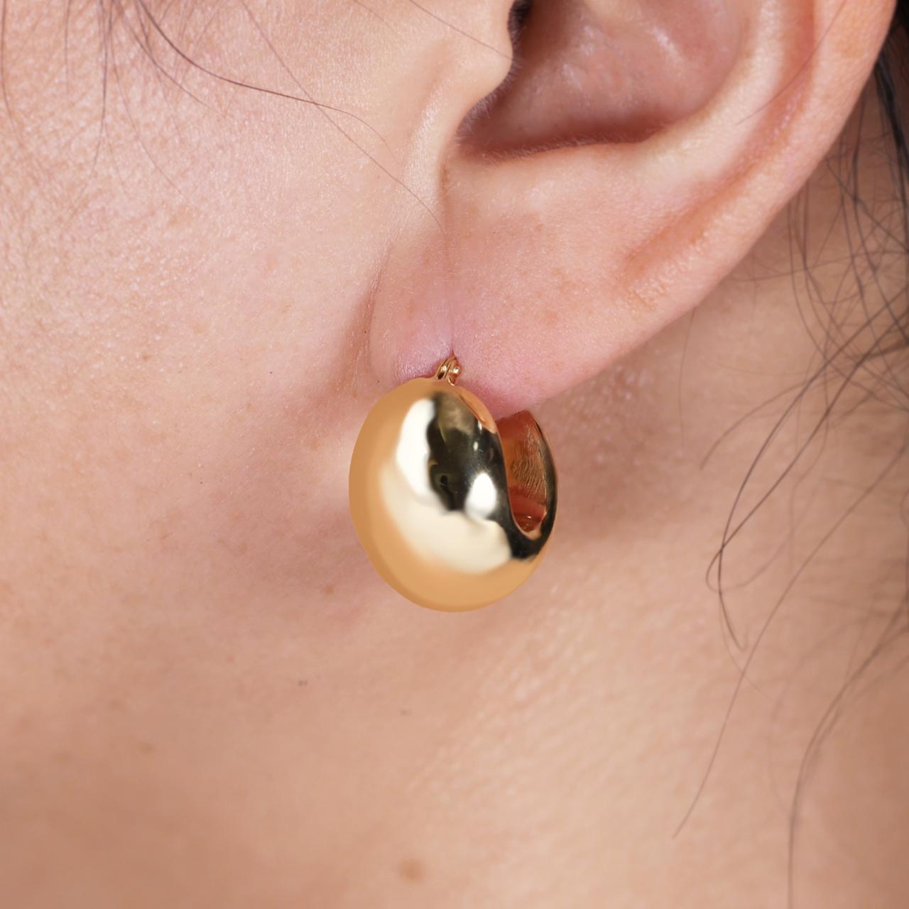 18ct yellow gold hollow chunky hoop earrings on the ear