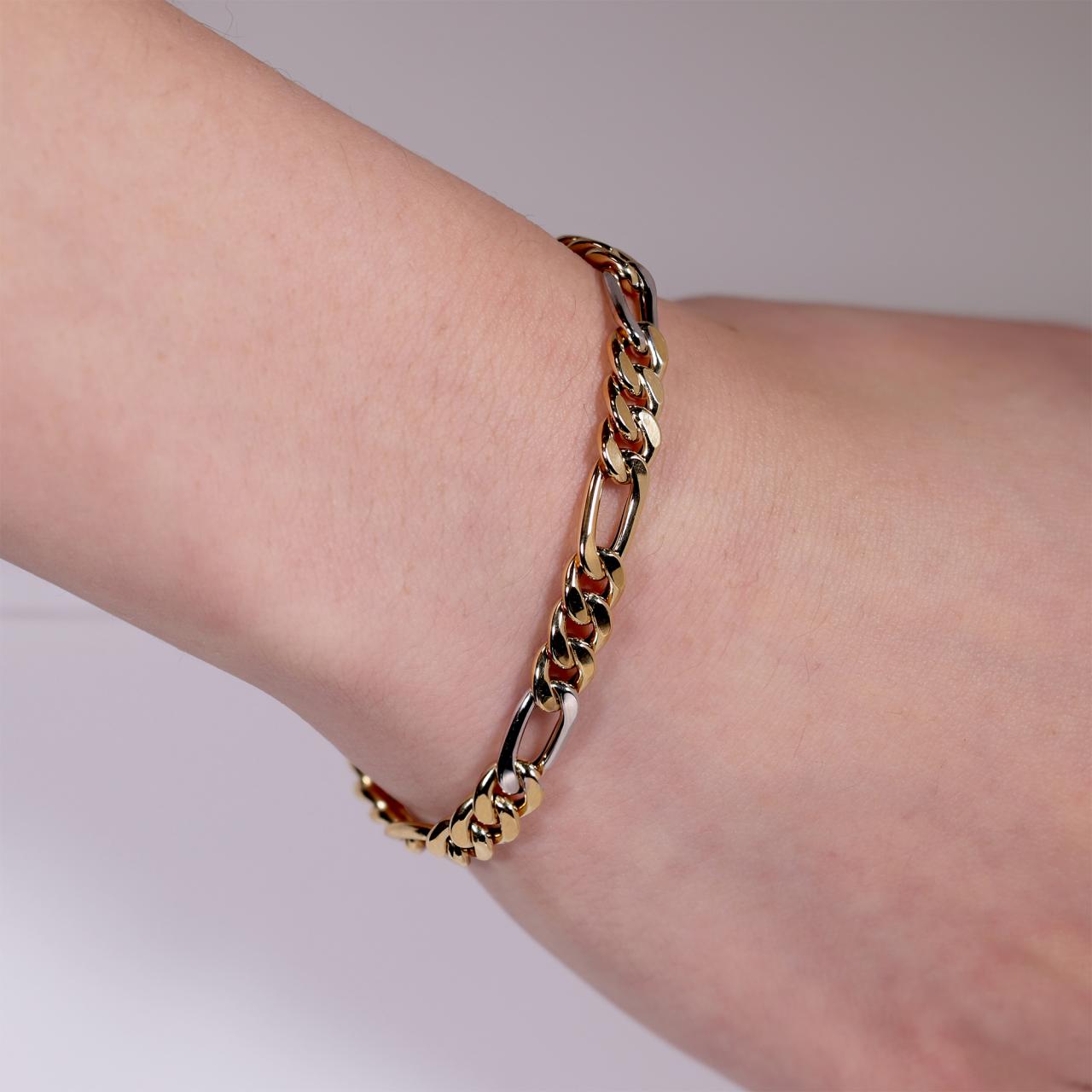 18ct yellow and white gold 21cm diamond cut figaro link bracelet on the wrist