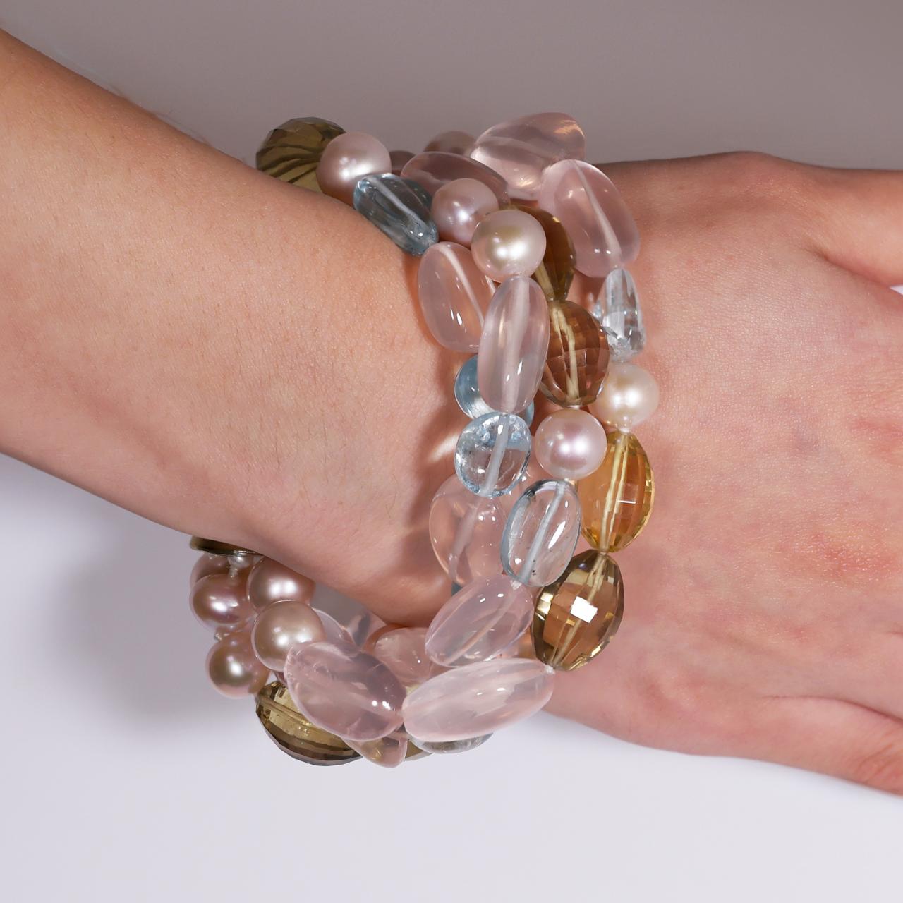 Aquamarine, Rose Quartz, Lemon Quartz beads and Fresh Water Pearls four rows bracelet on the wrist