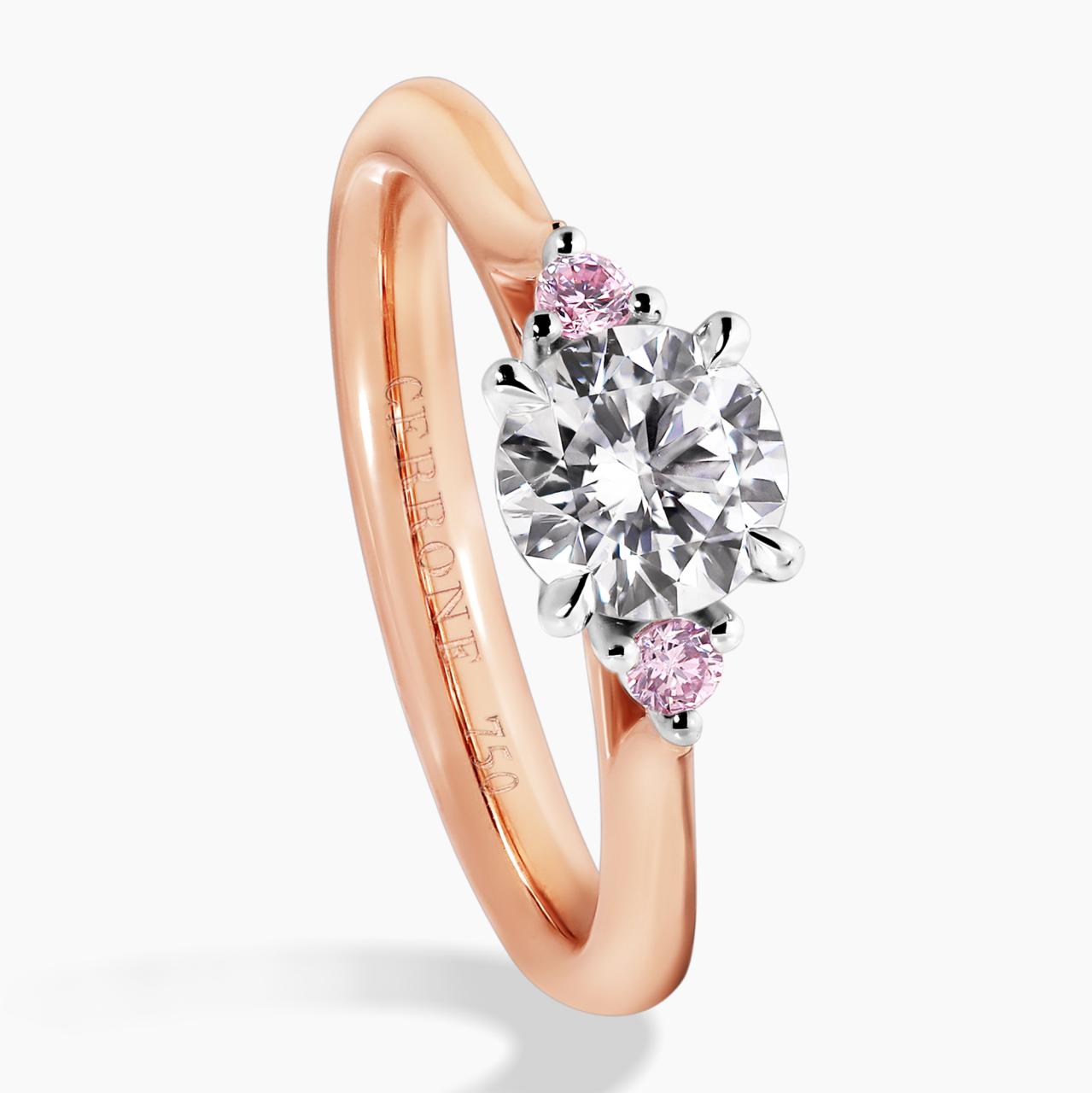 18ct white and rose gold round brilliant cut diamond engagement ring with round pink diamonds on either side