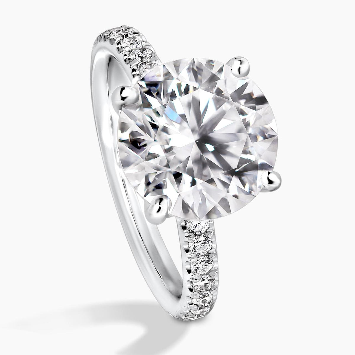 18ct white gold round briliant cut diamond engagement ring in a four claw setting with a hidden halo and diamond band side view