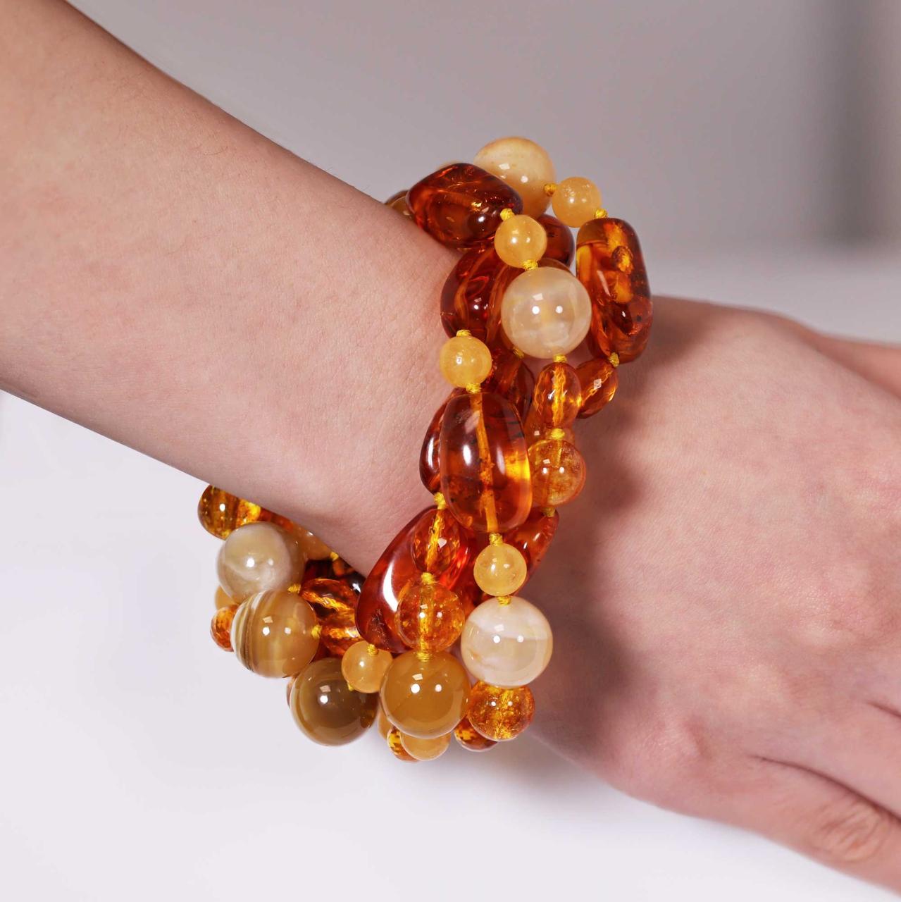 Four rows of mixed amber, yellow agate, yellow crystal and orange calcite beads bracelet ended with a silver magnetic clasp on the wrist