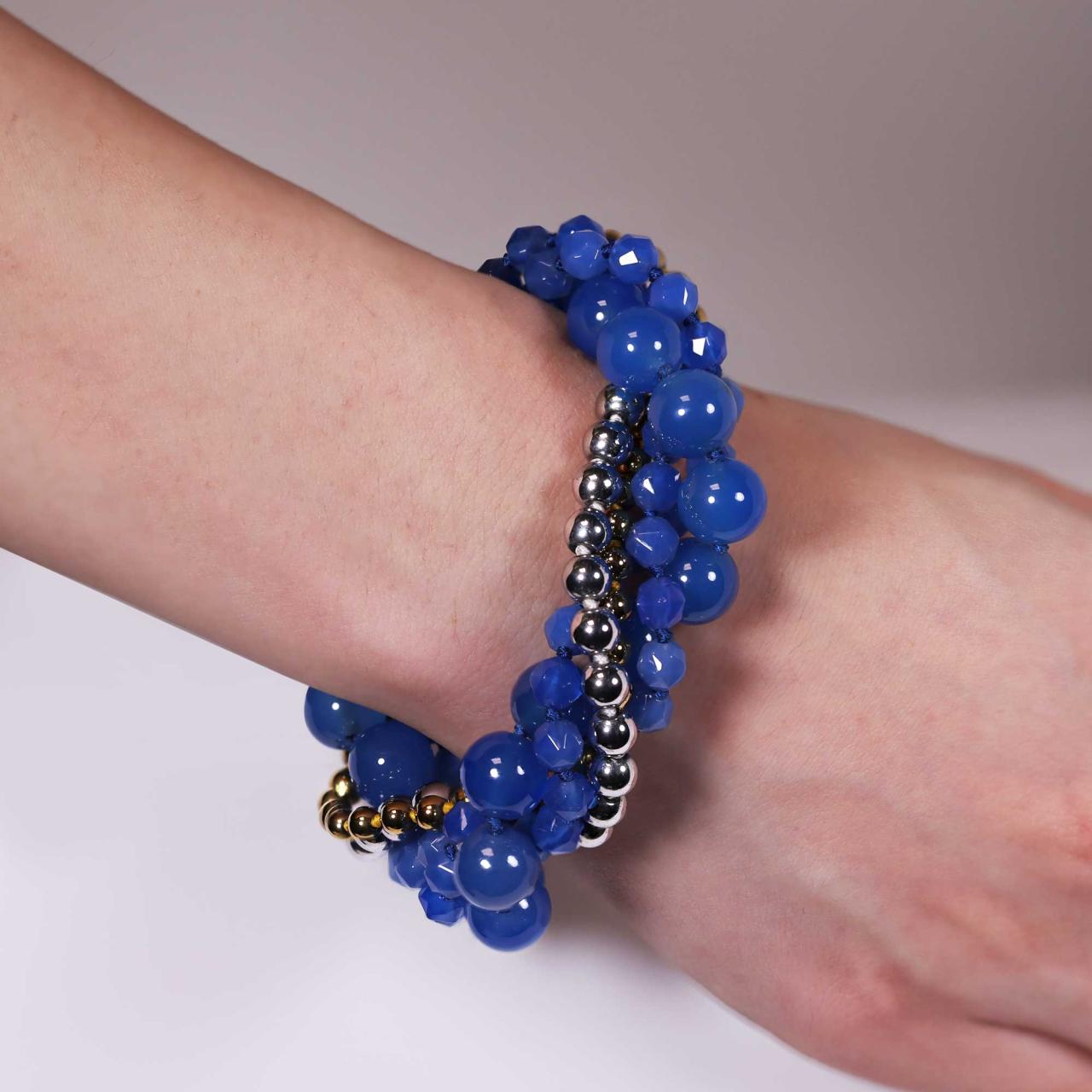Three rows of blue agate, single row of silver plate hemitite and single row of gold plated hemitite beads bracelet ended with a silver magnetic clasp on the wrist