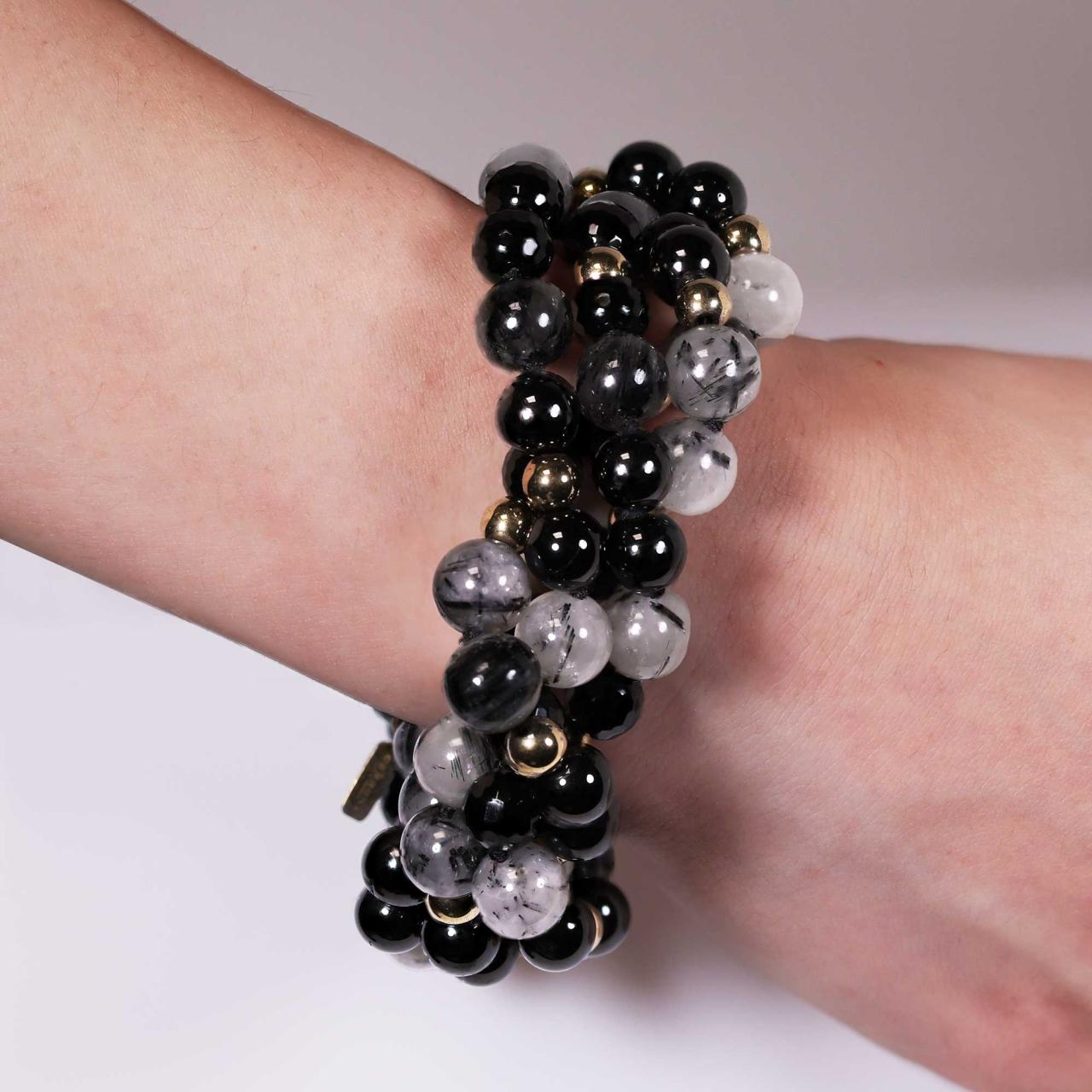 Four rows of black rutile, black tourmaline, onyx and gold plated hemitite beads bracelet ended with a gold plated silver magnetic clasp from the Carmela Cerrone Collection