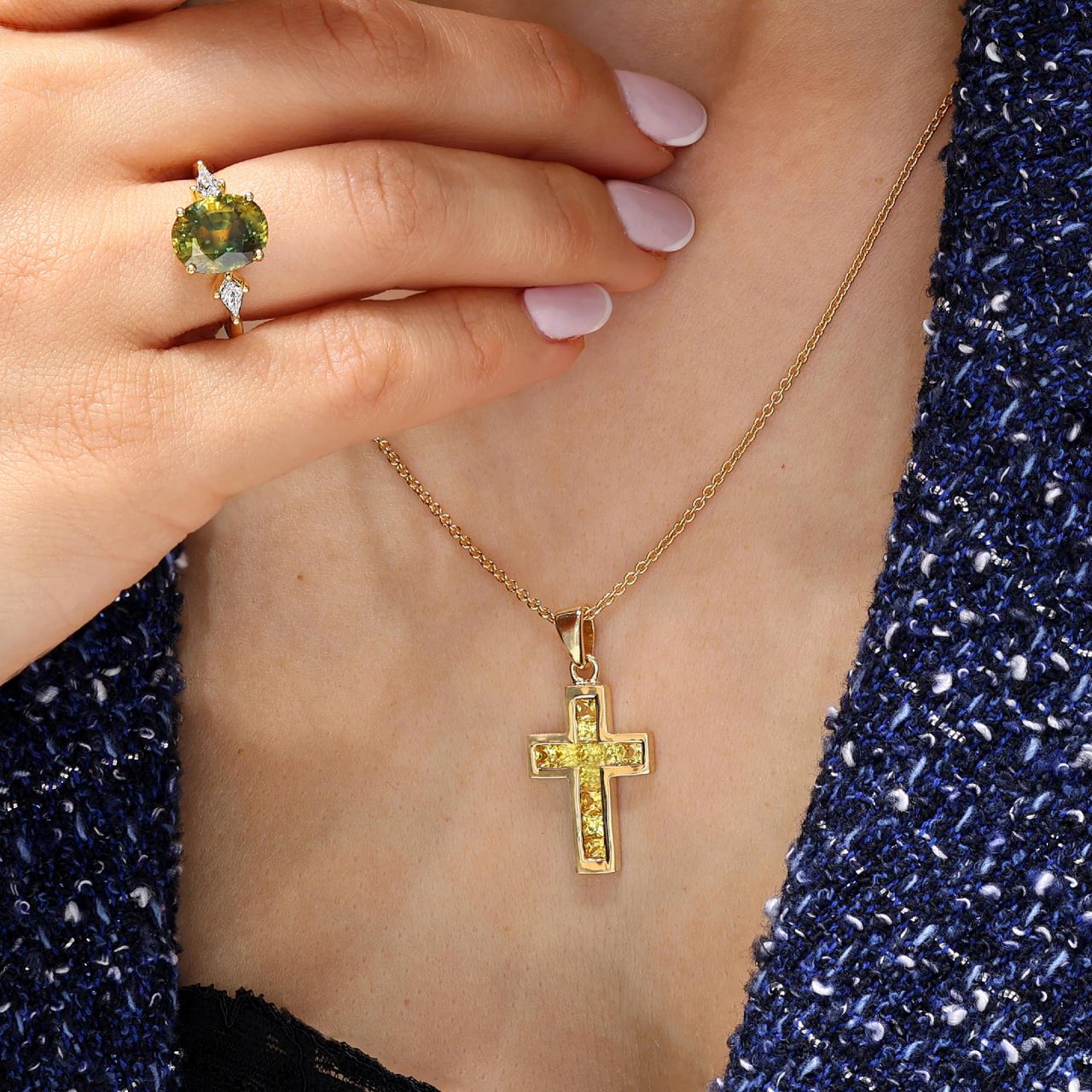 18ct yellow gold princess cut yellow sapphire cross pendant in a channel setting on the neck
