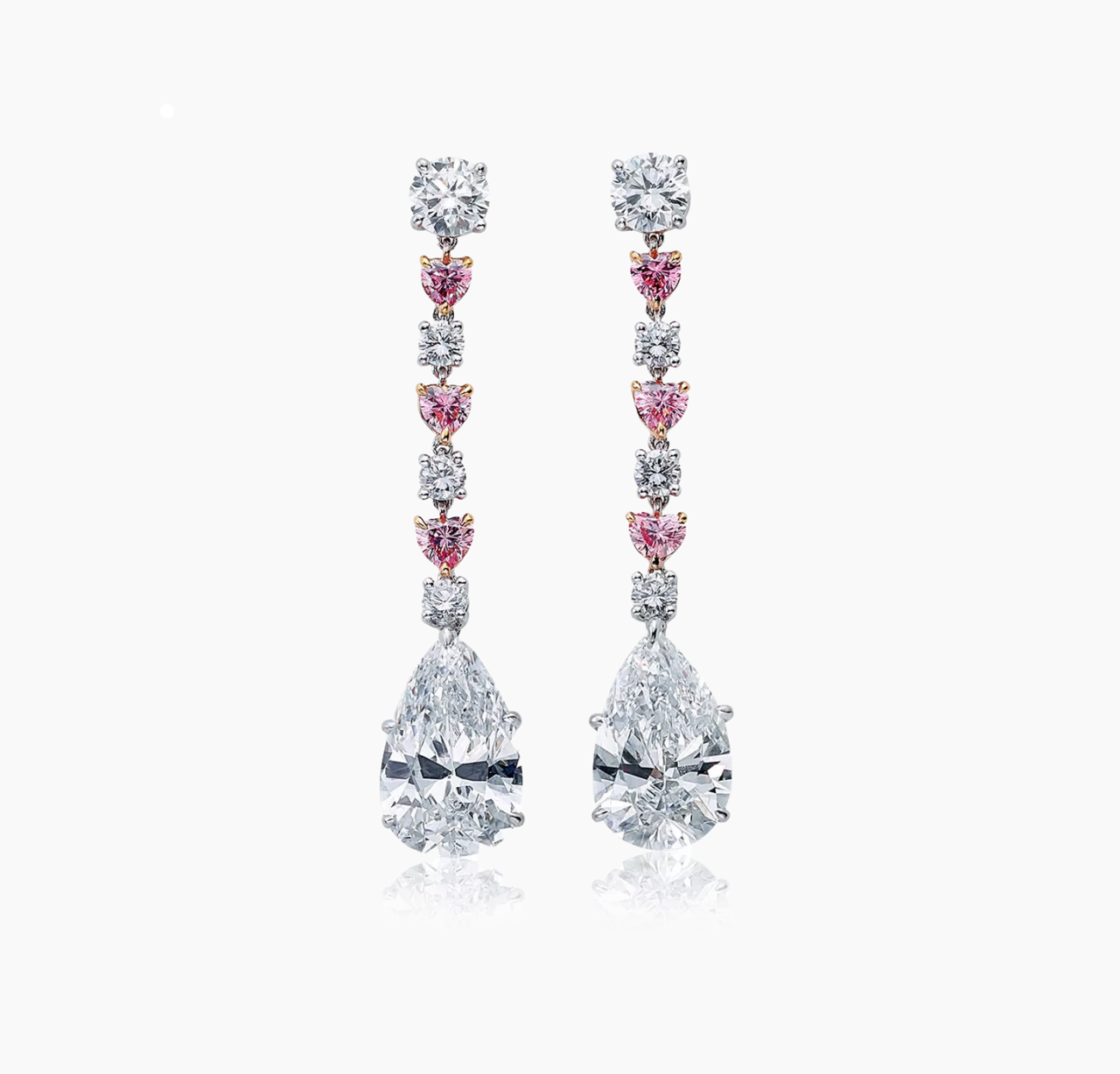 A pair of 18ct white and rose gold drop earrings featuring pear, heart, and round brilliant cut pink and white diamonds.