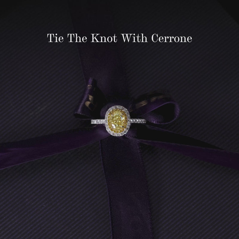 Platinum and 18ct yellow gold Fancy Intense Yellow oval and round brilliant cut diamond claw set double halo engagement ring video