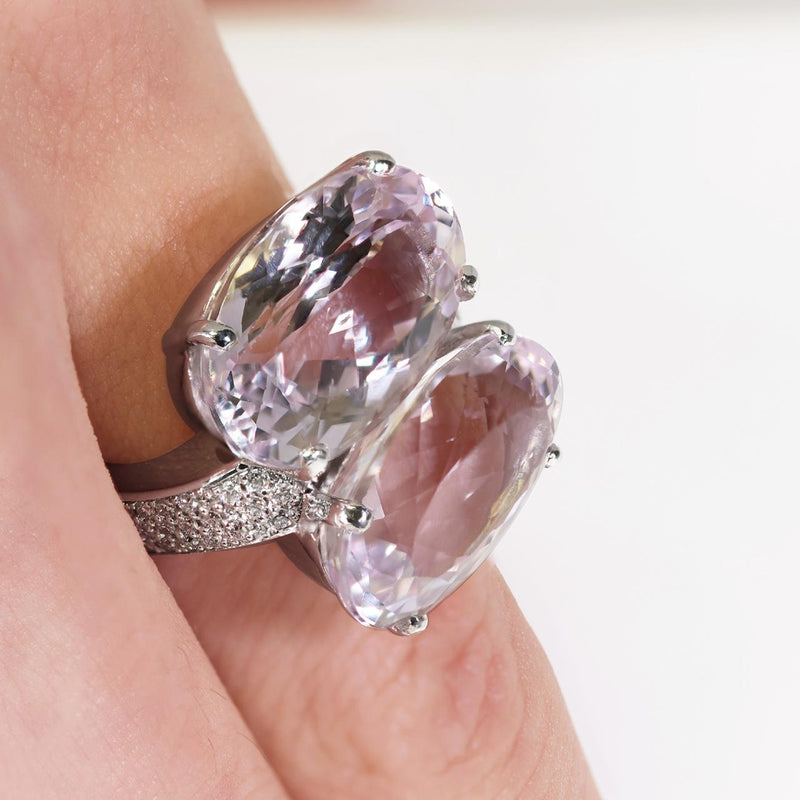 18ct white gold oval cut kunzite and diamond ring on the finger