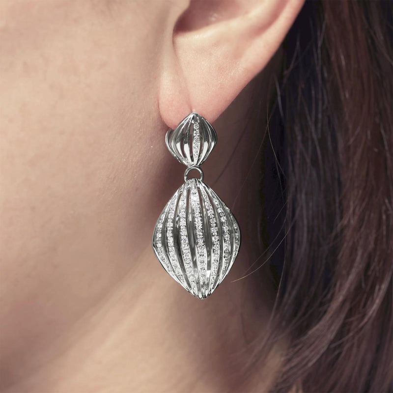 18ct White gold and diamond set fancy drop earrings on ear