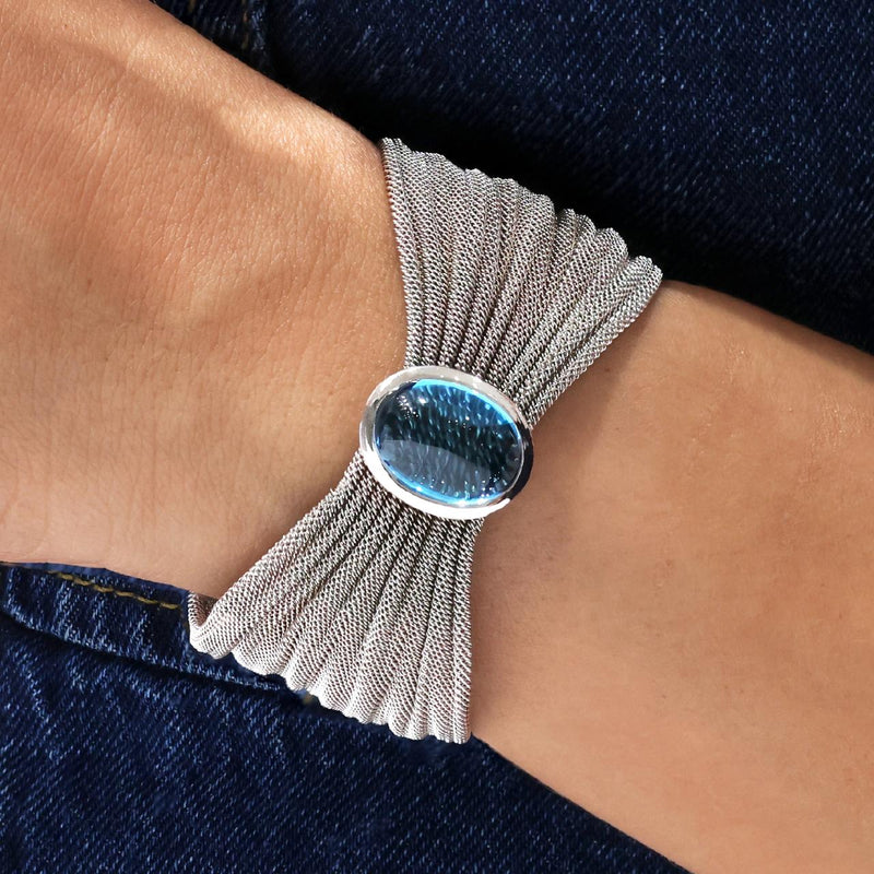 18ct white gold blue topaz bangle features cabochon blue topaz in bezel setting on the wrist