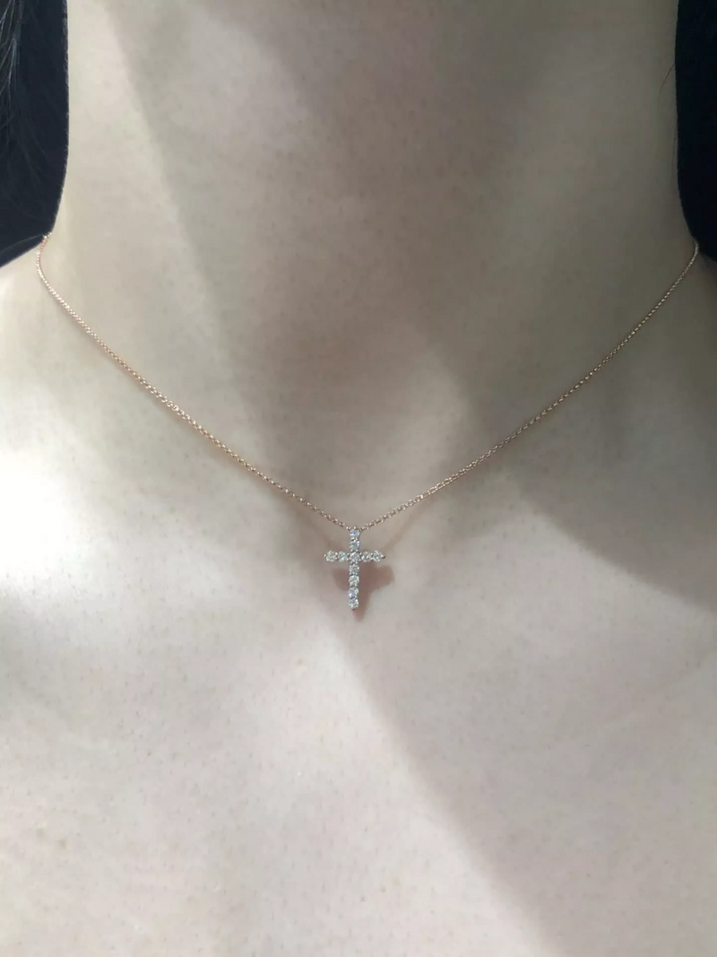 18ct rose gold 11=0.25ct diamond cross necklace on the neck