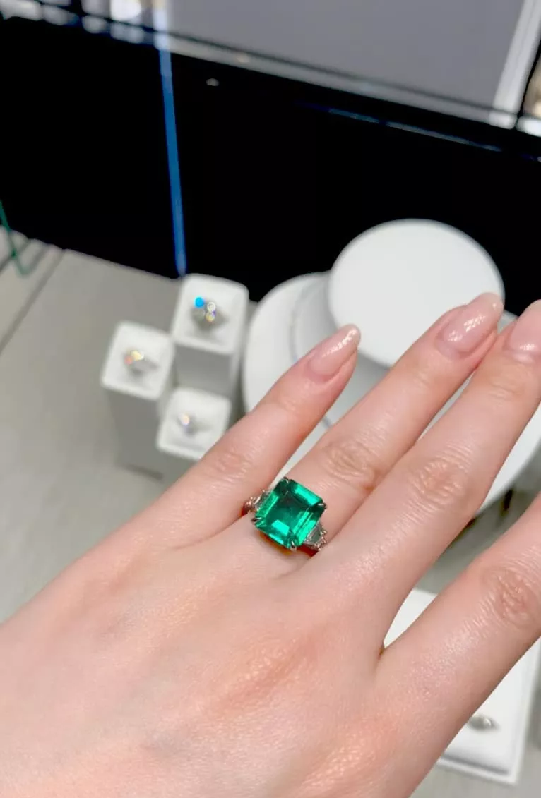 18ct white gold 3.95ct square emerald cut Colombian Emerald, step cut trapezoid and round brilliant cut diamond ring