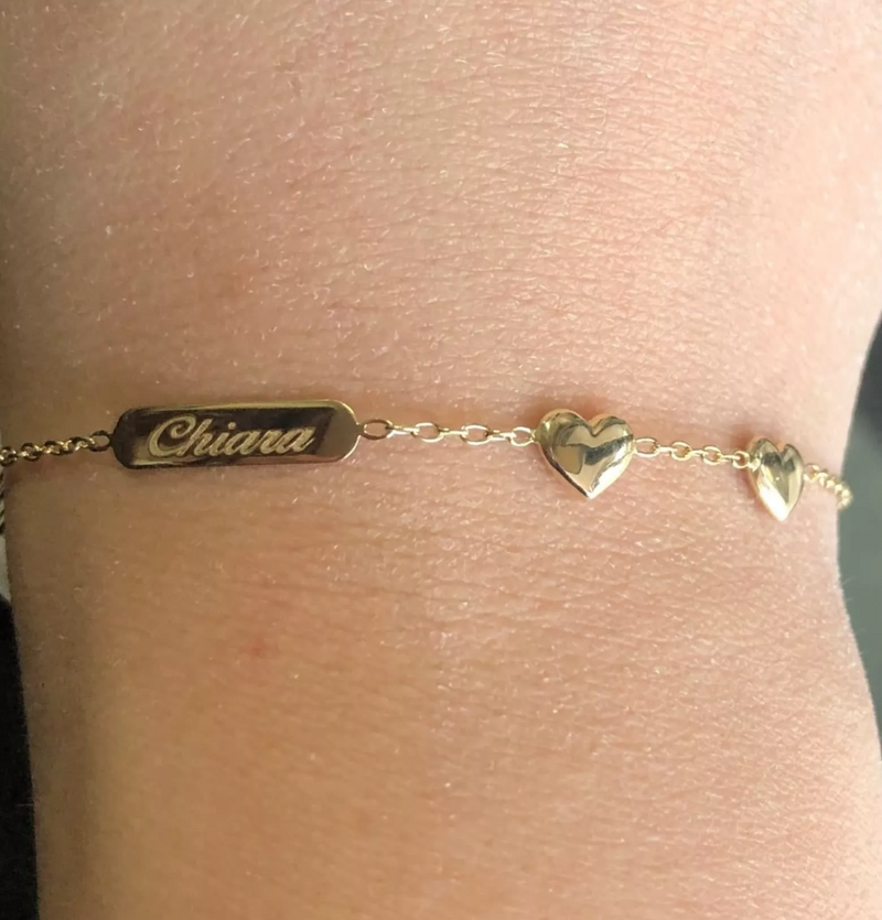 18ct Yellow Gold two Hearts & ID Baby Bracelet on the wrist with engraving