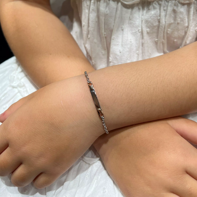 18ct white and rose gold ID tag baby bracelet on wrist
