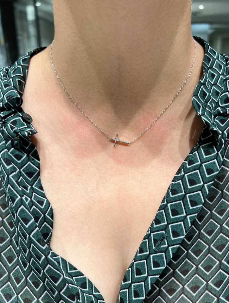 18ct white gold cross necklace displayed on the neck