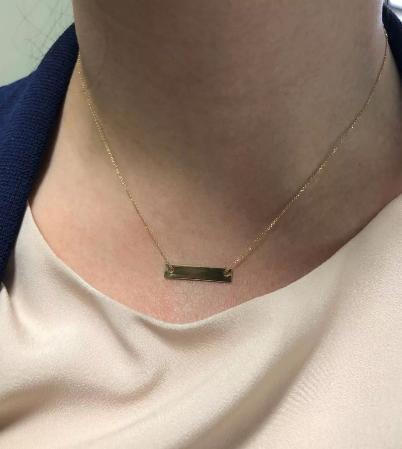 18ct rose gold bar shape necklace on the neck