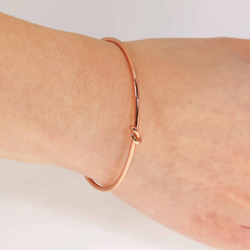 18ct rose gold knot bangle on the wrist