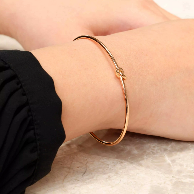 18ct rose gold knot bangle on the wrist