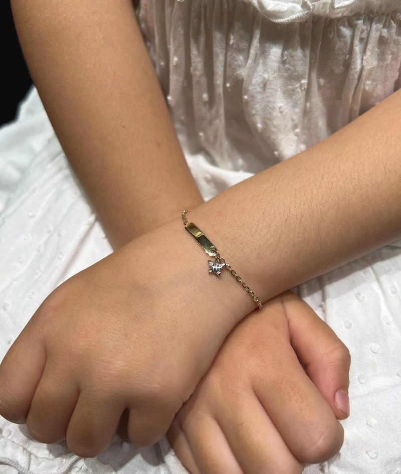 18ct yellow and white gold ID butterfly bracelet on the wrist