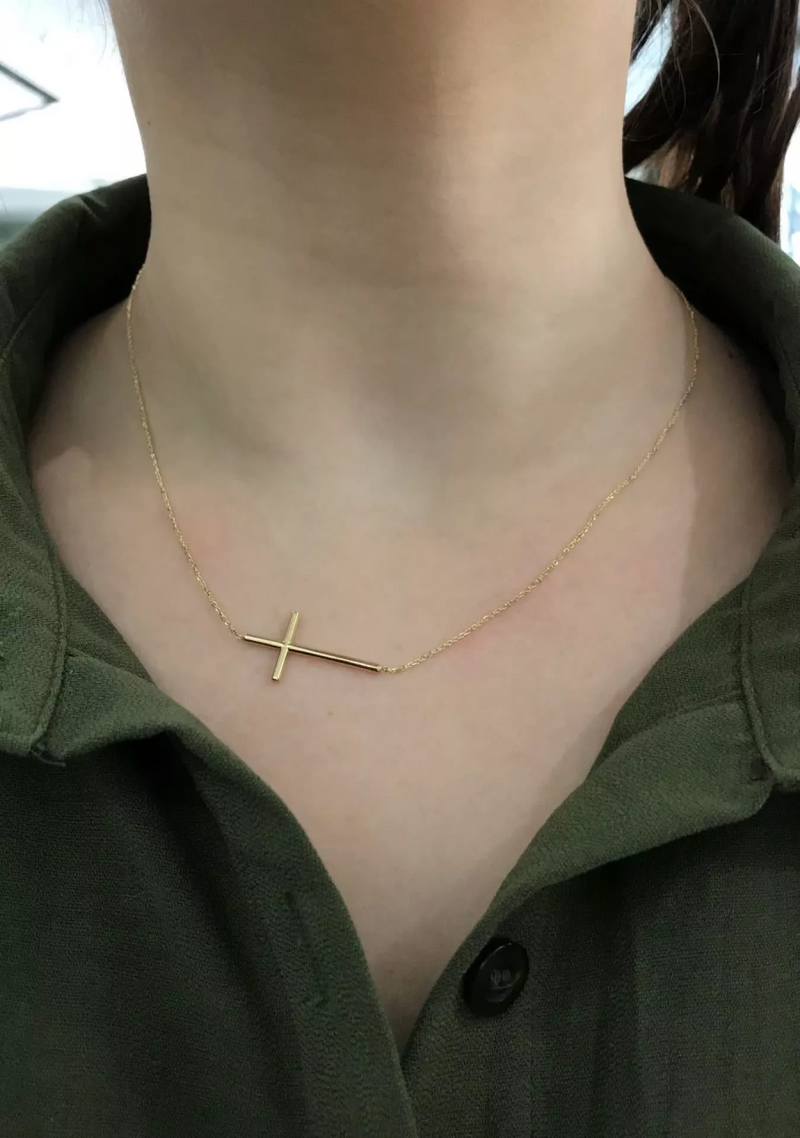 18ct yellow gold cross necklace on the neck