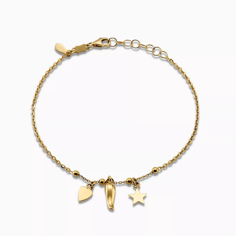 An 18ct yellow gold bracelet with a heart, corno and star charm attached to it, displayed against a white background.