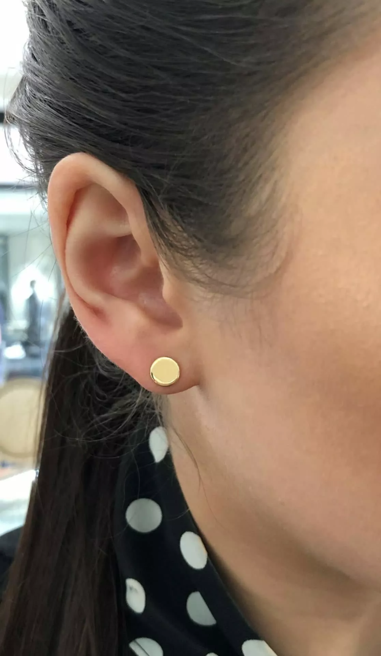 18ct yellow gold round plate earrings on ear