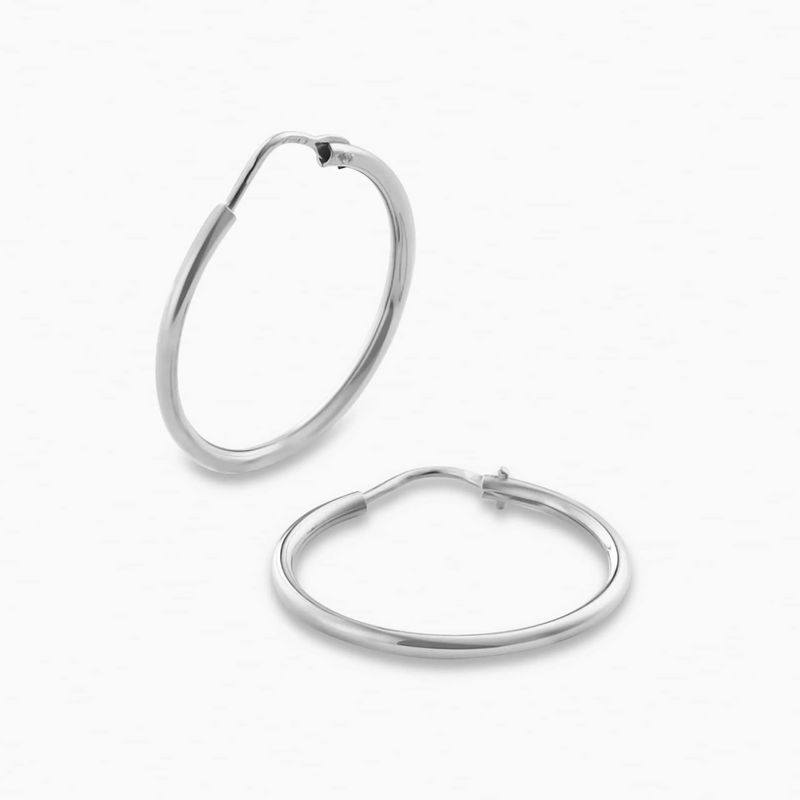 A pair of 18ct white gold 20mm hoop earrings on a white background.