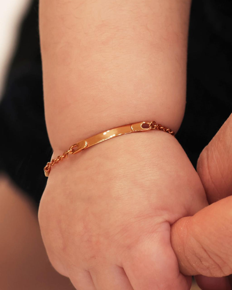 18ct rose gold identity baby bracelet on baby wrist
