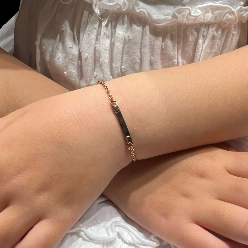 18ct rose gold identity baby bracelet on child's wrist