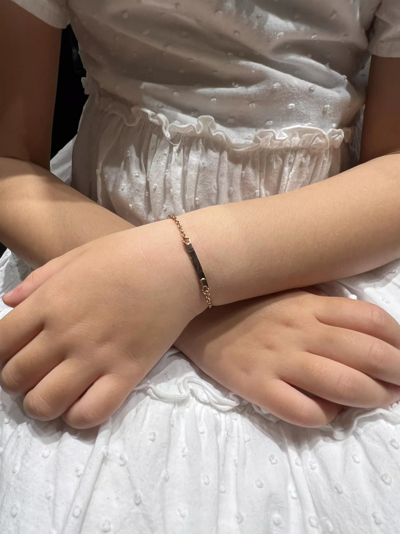 18ct rose gold identity baby bracelet on child's wrist