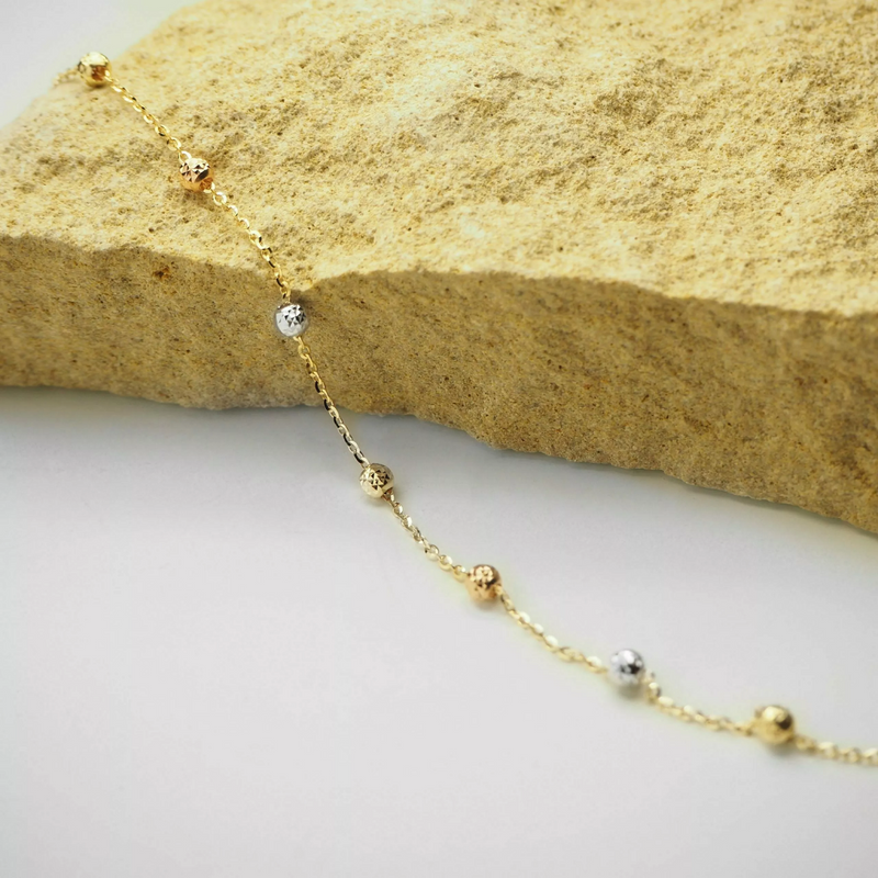 18ct yellow, white and rose gold bracelet with faceted balls